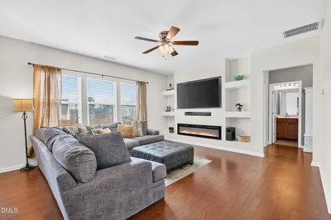a living room with fireplace furniture and a flat screen tv