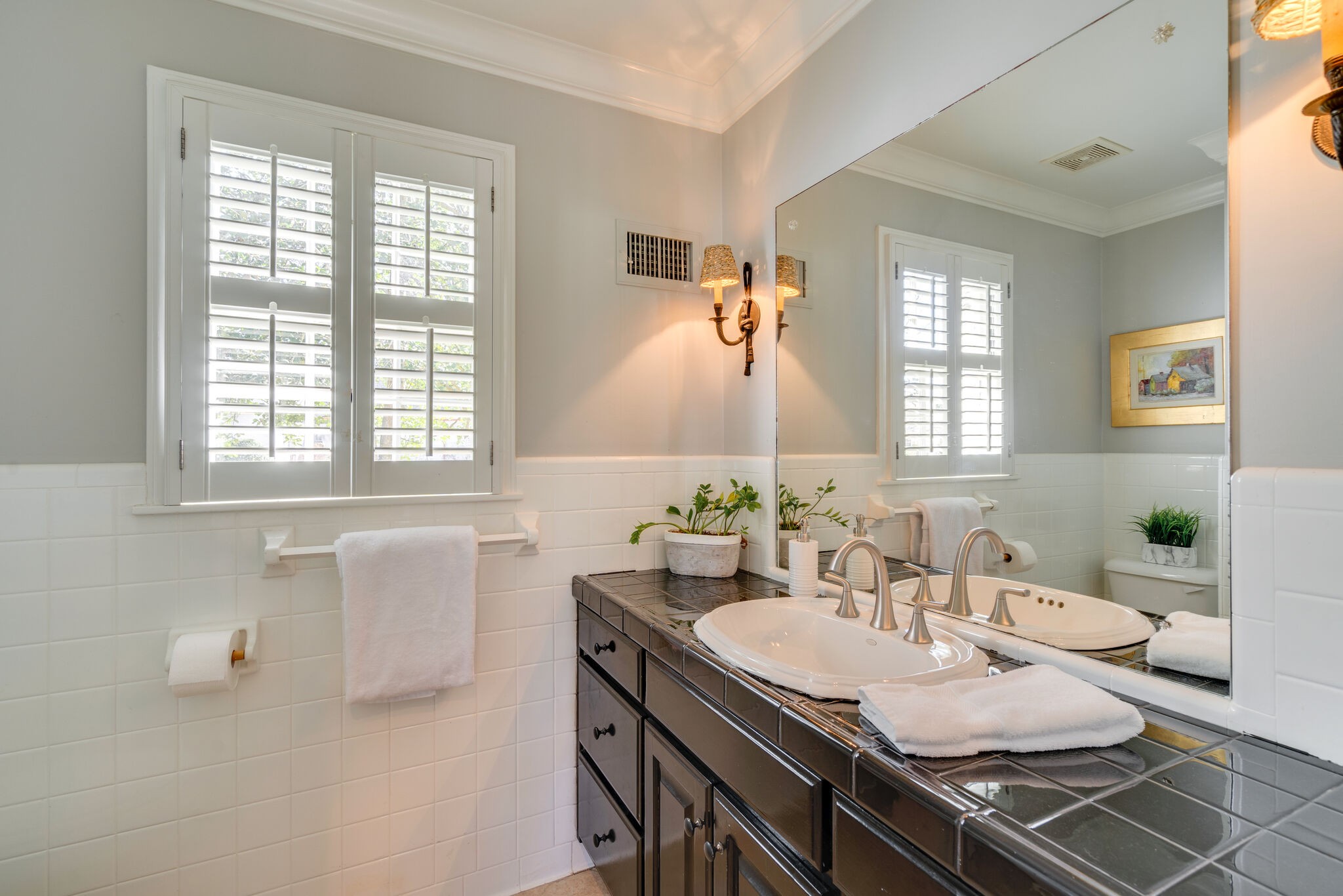 411 Page Road Nashville, TN 37205 - Photo 18 of 53 a bathroom with a granite countertop sink a toilet a mirror and a window