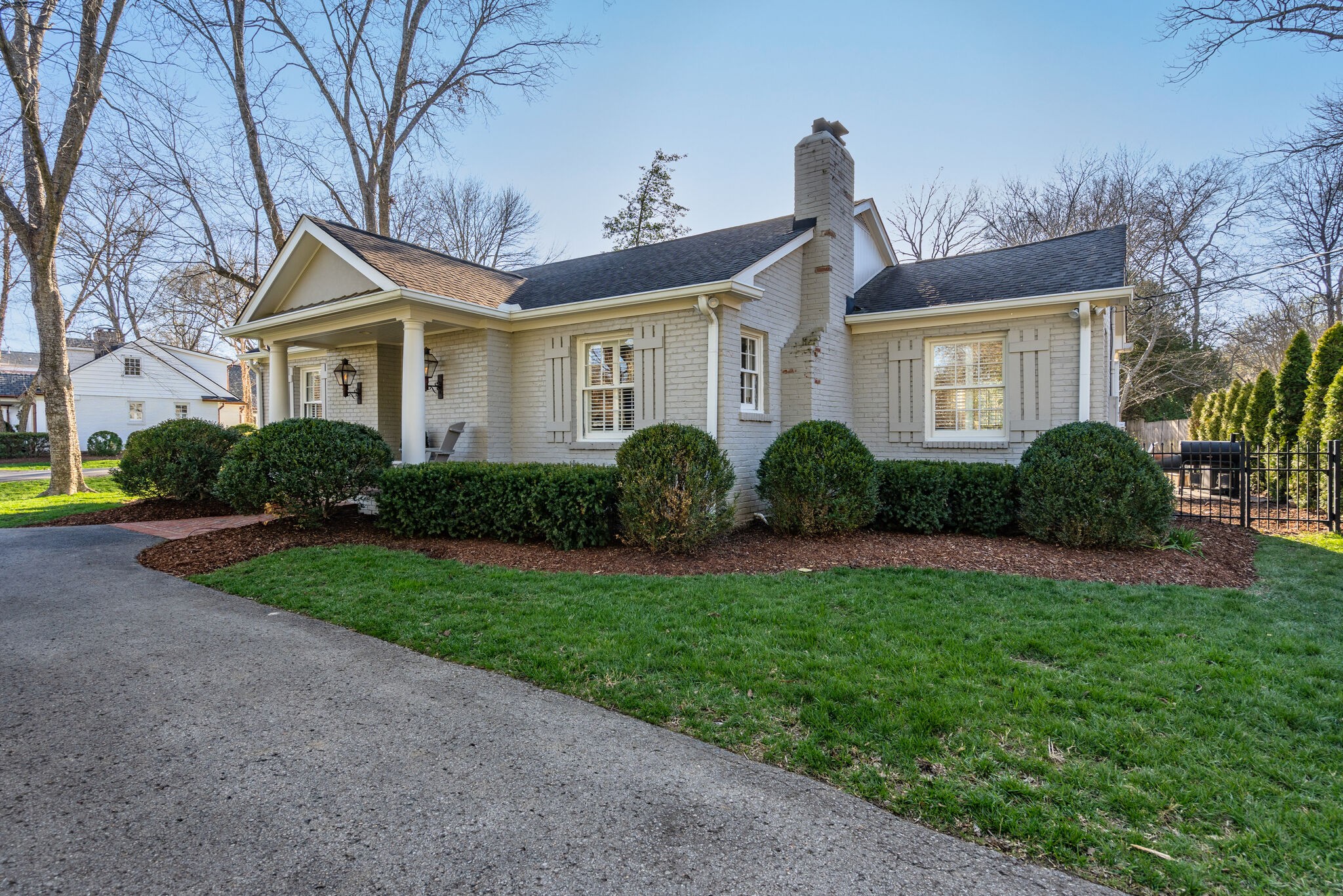 411 Page Road Nashville, TN 37205 - Photo 2 of 53 a front view of a house with a garden and plants