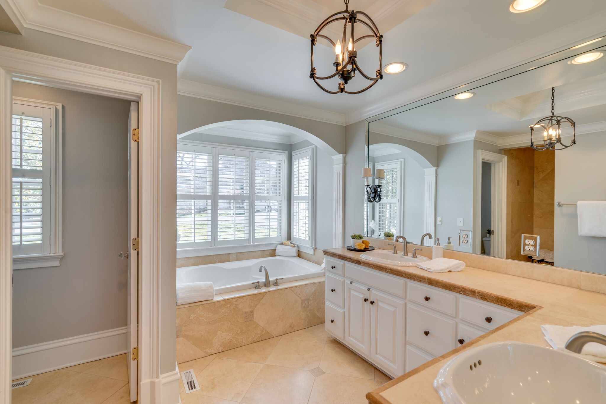 411 Page Road Nashville, TN 37205 - Photo 22 of 53 a spacious bathroom with a double vanity sink a large mirror and a bathtub