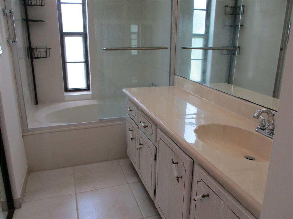 9233 Southwest 8th Street, Unit 311 Boca Raton, FL 33428 - Photo 12 of 19 a bathroom with a sink and a large mirror