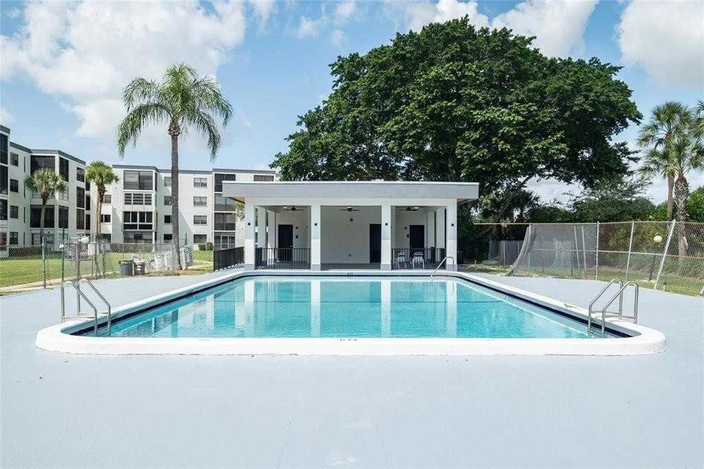 9233 Southwest 8th Street, Unit 311 Boca Raton, FL 33428 - Photo 3 of 19 a view of outdoor space yard swimming pool and patio