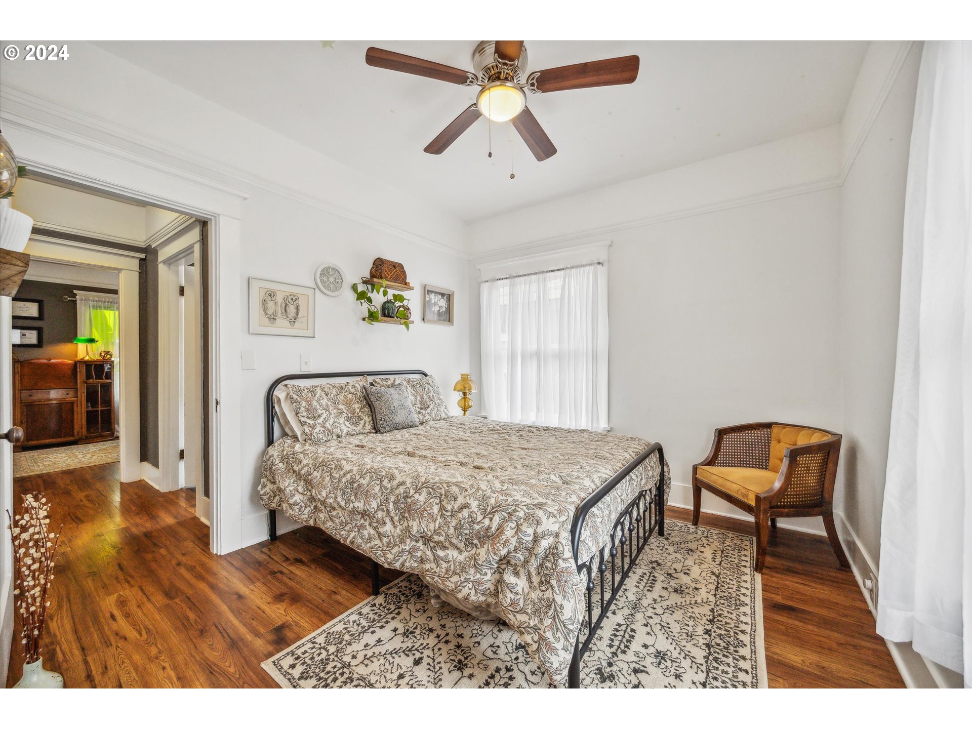 413 North 1st Avenue Ridgefield, WA 98642 - Photo 21 of 36 a bedroom with a bed and a chandelier