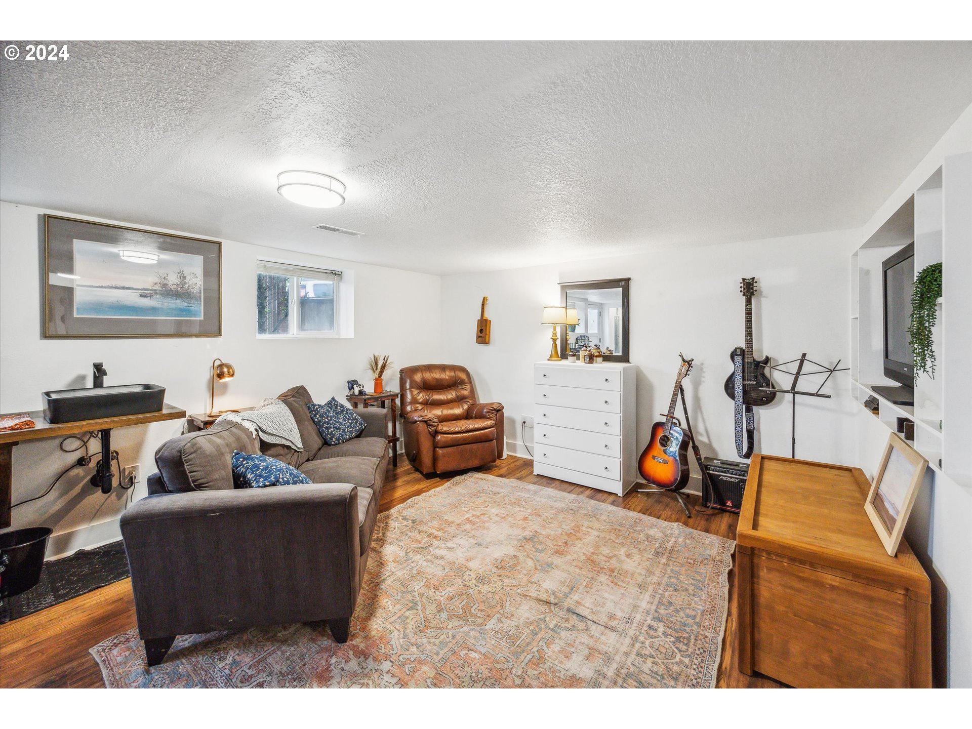 413 North 1st Avenue Ridgefield, WA 98642 - Photo 25 of 36 a living room with furniture and a flat screen tv