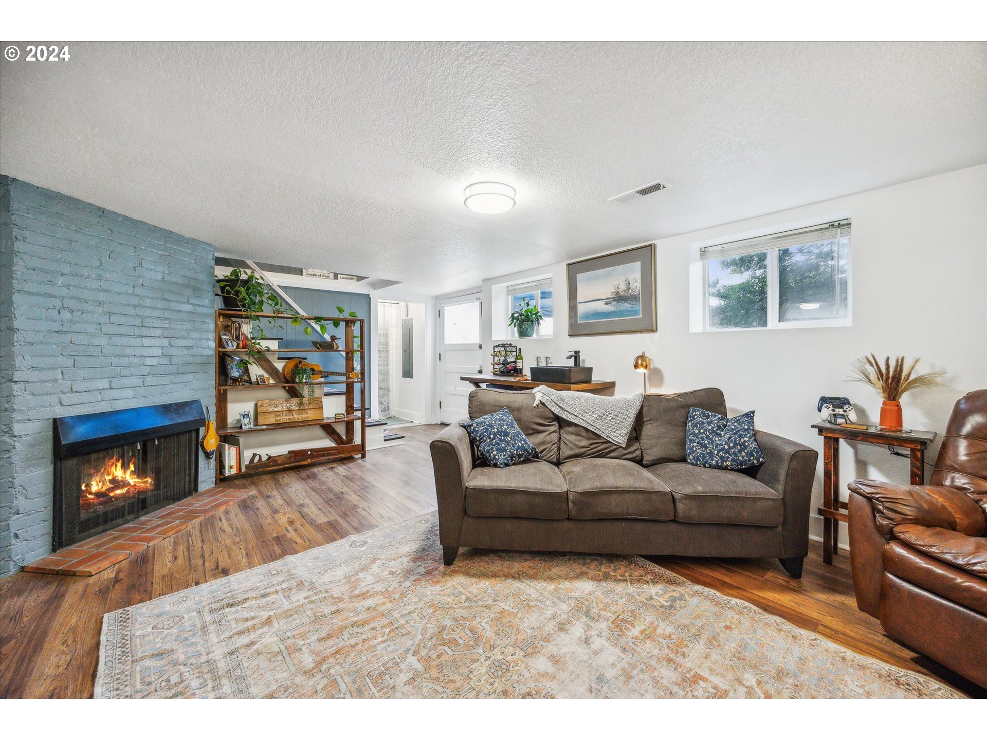 413 North 1st Avenue Ridgefield, WA 98642 - Photo 26 of 36 a living room with furniture and a fireplace