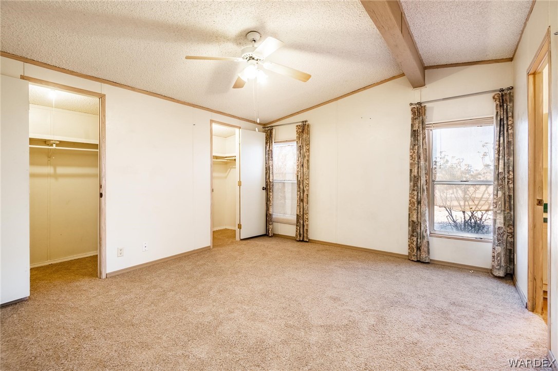 4496 Cowlic Road Golden Valley, AZ 86413 - Photo 13 of 50 an empty room with windows and entrance