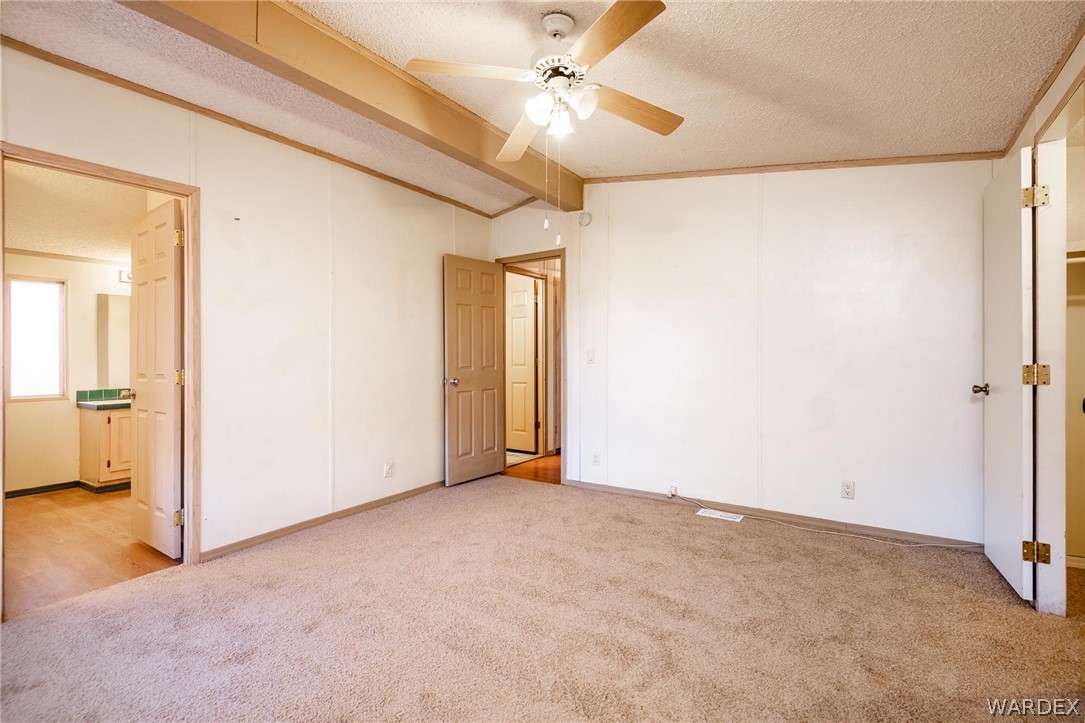 4496 Cowlic Road Golden Valley, AZ 86413 - Photo 15 of 50 a view of an empty room and a ceiling fan