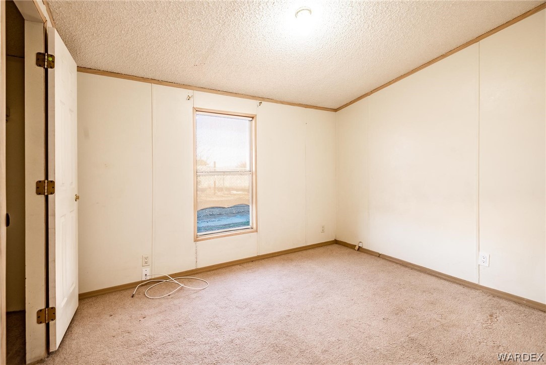 4496 Cowlic Road Golden Valley, AZ 86413 - Photo 18 of 50 a view of an empty room with a window