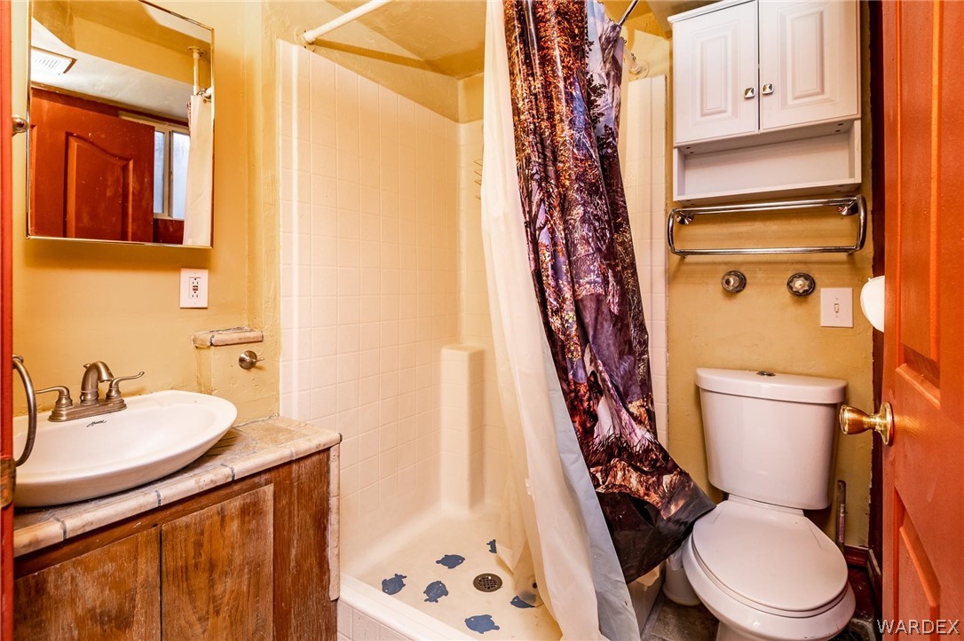 4496 Cowlic Road Golden Valley, AZ 86413 - Photo 26 of 50 a white toilet sitting next to a bathroom sink