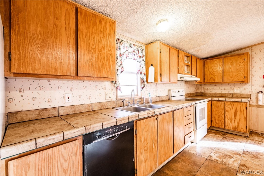4496 Cowlic Road Golden Valley, AZ 86413 - Photo 3 of 50 a kitchen with a sink stove and cabinets