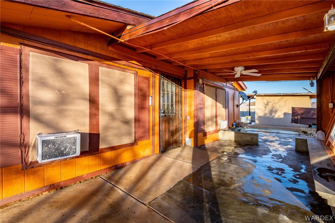 4496 Cowlic Road Golden Valley, AZ 86413 - Photo 31 of 50 a bedroom with furniture and large windows