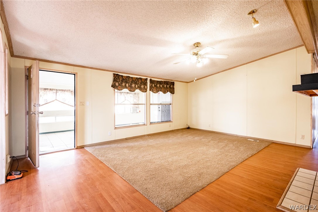 4496 Cowlic Road Golden Valley, AZ 86413 - Photo 7 of 50 wooden floor in an empty room with a window