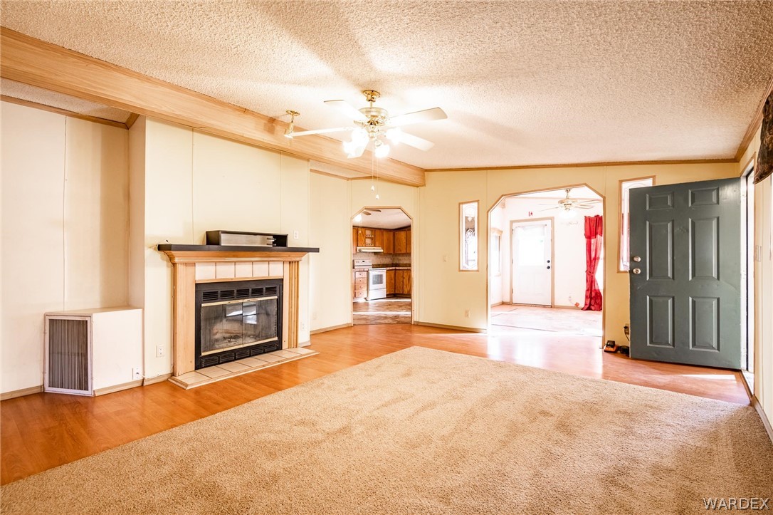 4496 Cowlic Road Golden Valley, AZ 86413 - Photo 8 of 50 a view of empty room with fireplace and fan