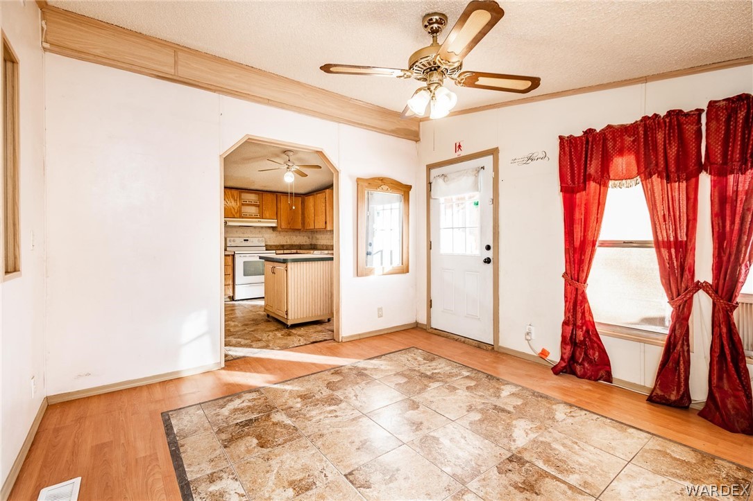 4496 Cowlic Road Golden Valley, AZ 86413 - Photo 9 of 50 a view of a kitchen with wooden floor and a refrigerator
