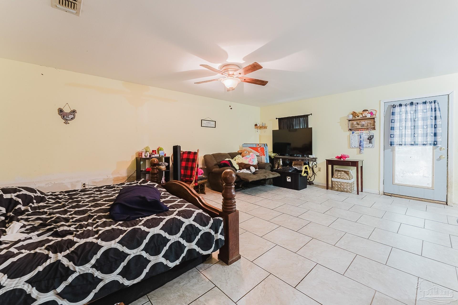 9543 Quiet Creek Road Milton, FL 32570 - Photo 13 of 16 a bedroom with a bed and a flat tv screen on the dresser