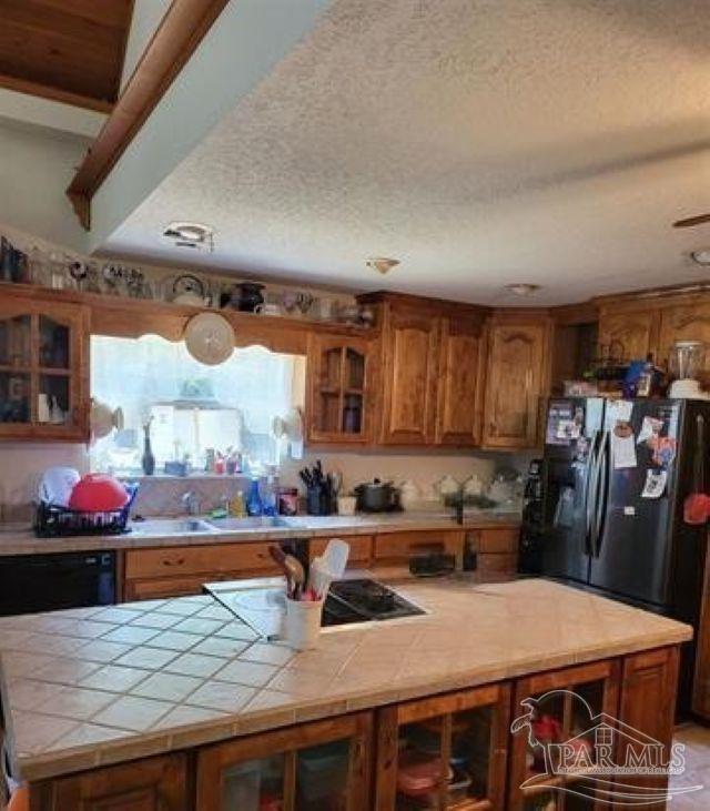 9543 Quiet Creek Road Milton, FL 32570 - Photo 9 of 16 a kitchen with stainless steel appliances kitchen island granite countertop a table chairs and a refrigerator