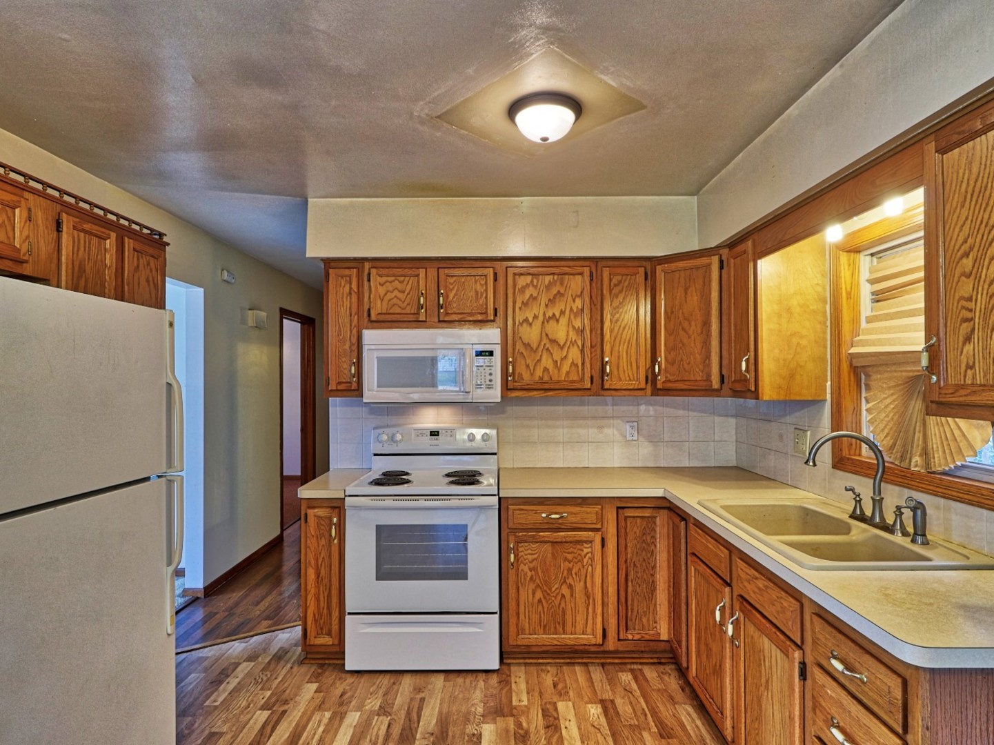 5159 West Margaret Street Monee, IL 60449 - Photo 7 of 13 a kitchen with stainless steel appliances a stove sink and refrigerator