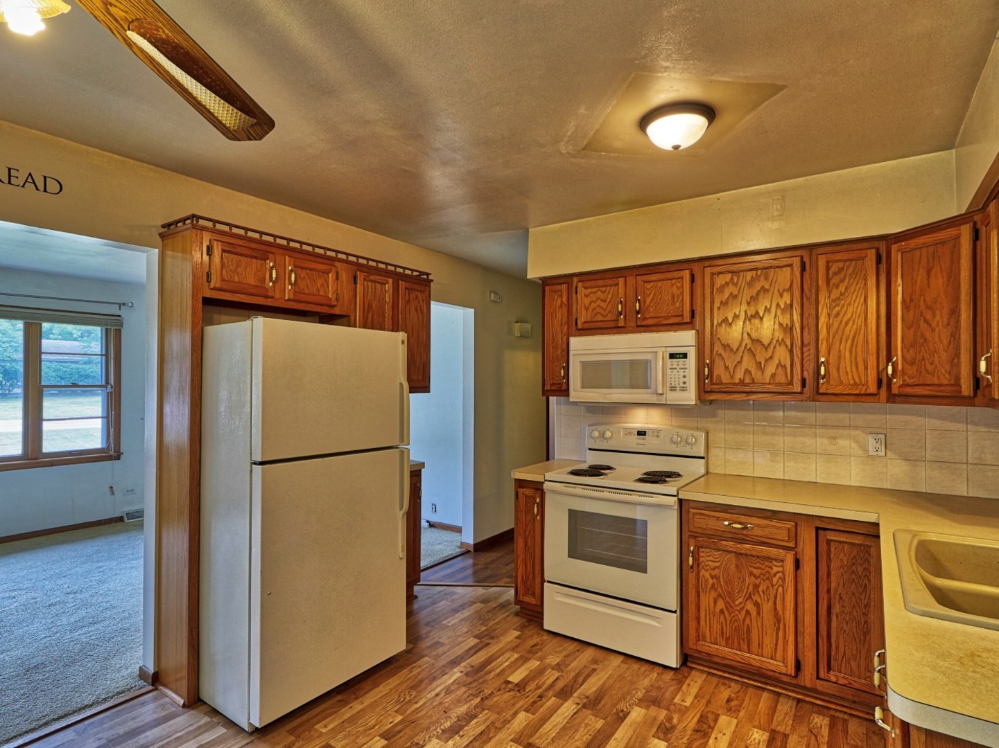 5159 West Margaret Street Monee, IL 60449 - Photo 8 of 13 a kitchen with a refrigerator sink and stove