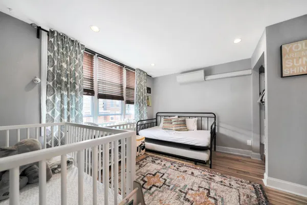 a bedroom with furniture and a window