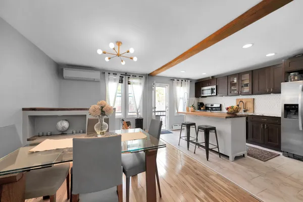 a view of a dining room with furniture window and wooden floor