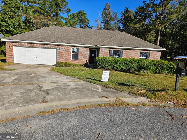 a aerial view of a house next to a yard
