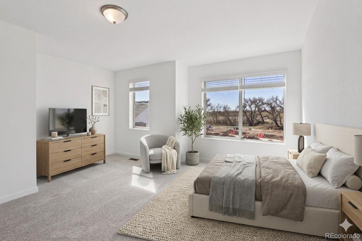 15339 West 68th Loop Arvada, CO 80007 - Photo 2 of 2 a large bedroom with a bed and large windows