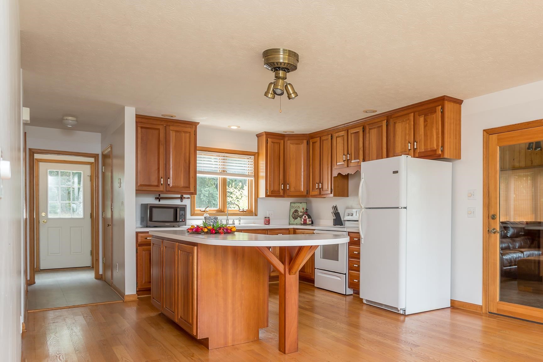 693 Stover Shop Road Churchville, VA 24421 - Photo 12 of 42 a kitchen with stainless steel appliances a refrigerator a stove a sink dishwasher and white cabinets with wooden floor