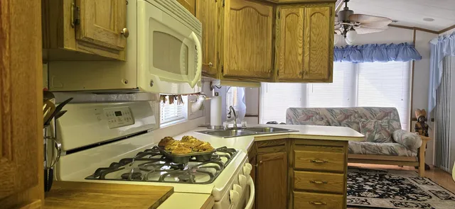 a kitchen with a stove a sink and a refrigerator