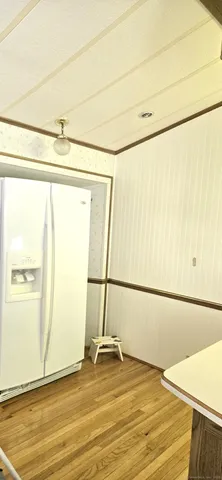 a view of a room with wooden floor and a window