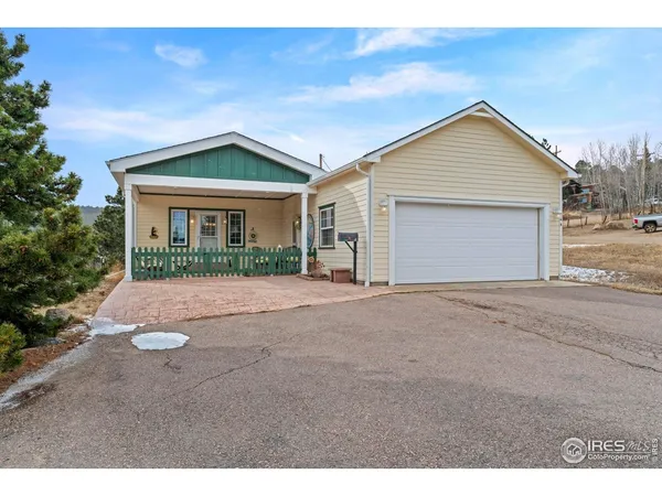 a view of a house with a yard and garage