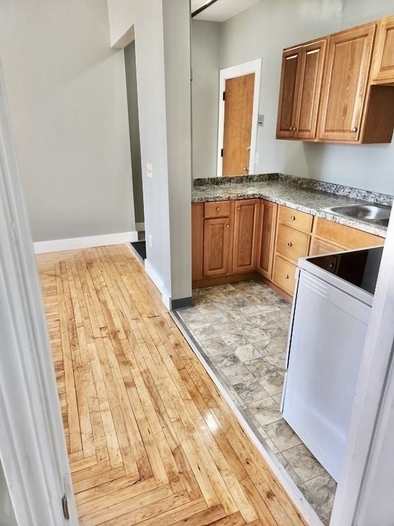 15 North Main Street, Unit 25 Attleboro, MA 02703 - Photo 1 of 4 a kitchen with granite countertop white cabinets and sink