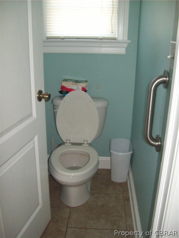 672 Lillys Neck Road Moon, VA 23119 - Photo 35 of 49 a white toilet sitting next to a bathroom sink