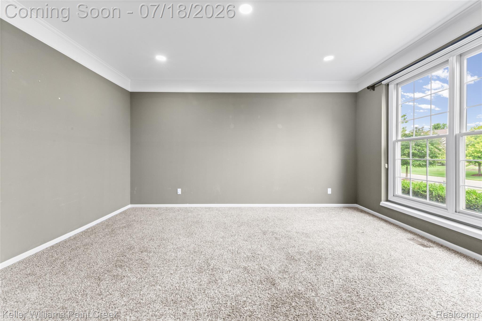 4230 Holly Lane Rochester, MI 48306 - Photo 8 of 64 Expansive room featuring multiple windows, recessed lighting, crown molding, light-toned carpeting, and a neutral wall color