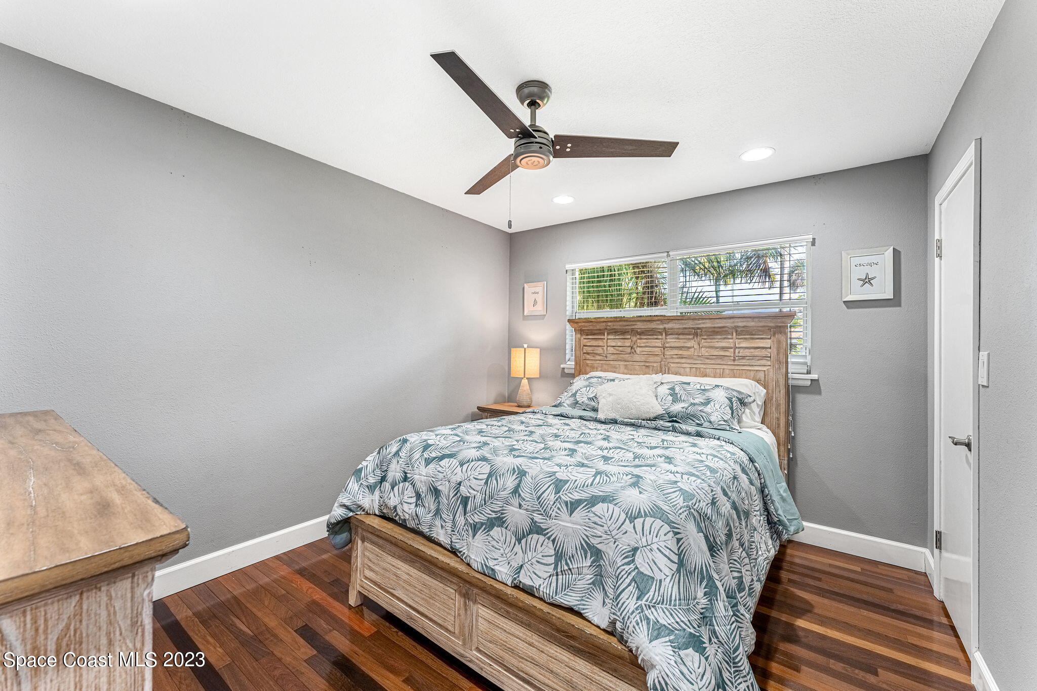425 Cinnamon Drive Satellite Beach, FL 32937 - Photo 32 of 55 a bedroom with a bed and wooden floor