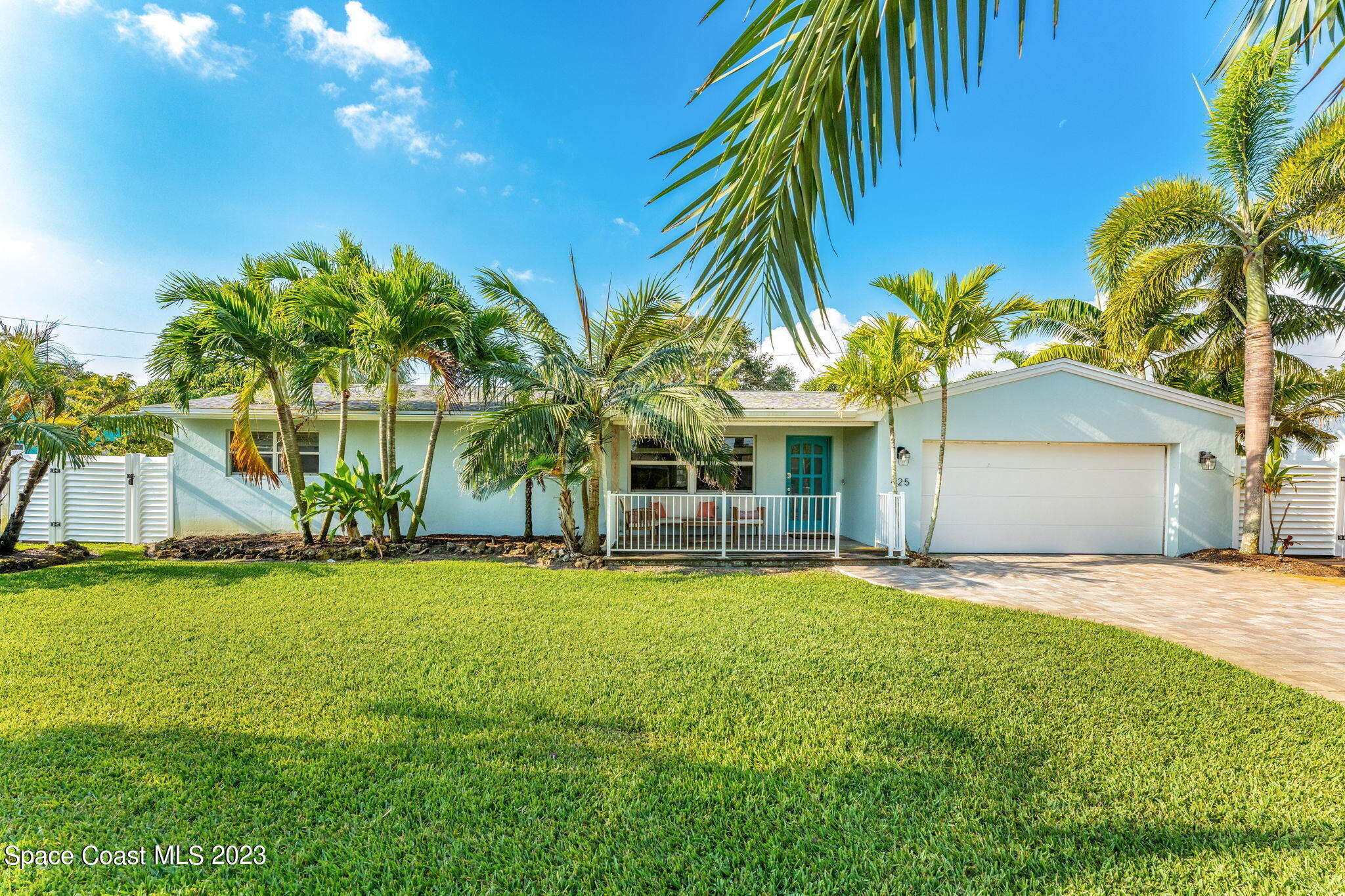 425 Cinnamon Drive Satellite Beach, FL 32937 - Photo 7 of 55 a front view of house with yard and palm tree