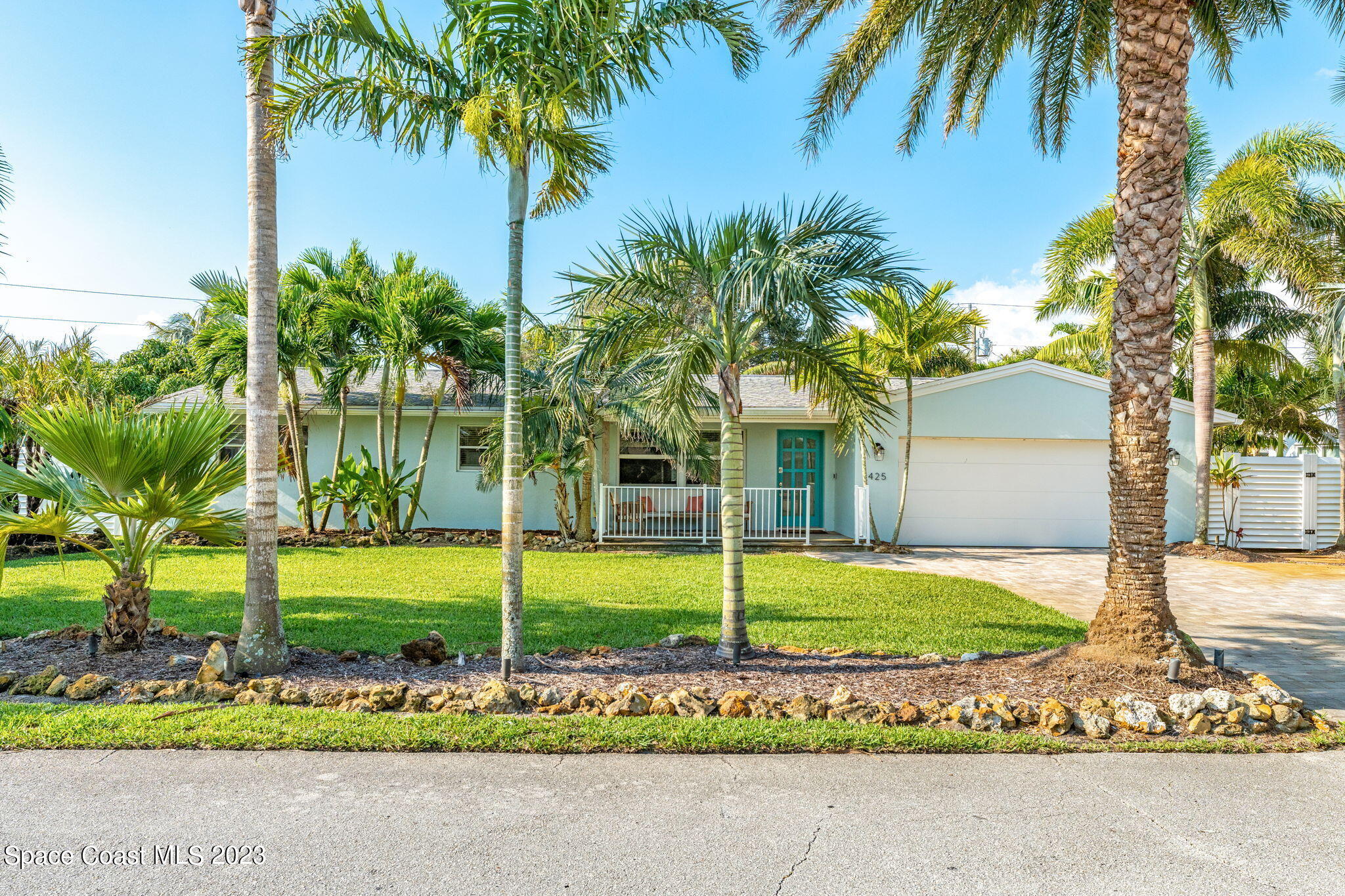 425 Cinnamon Drive Satellite Beach, FL 32937 - Photo 8 of 55 a view of a house with a big yard and palm trees