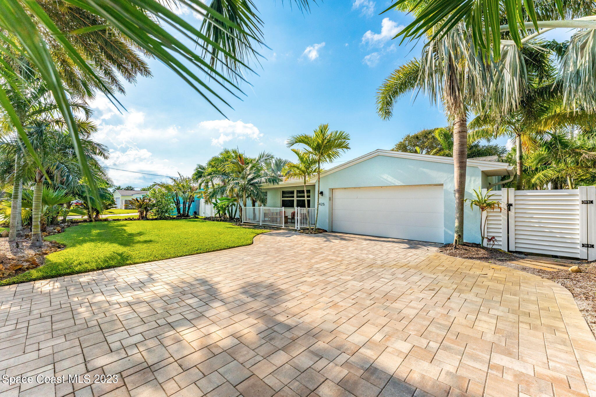 425 Cinnamon Drive Satellite Beach, FL 32937 - Photo 9 of 55 a view of a house with a yard and potted plants