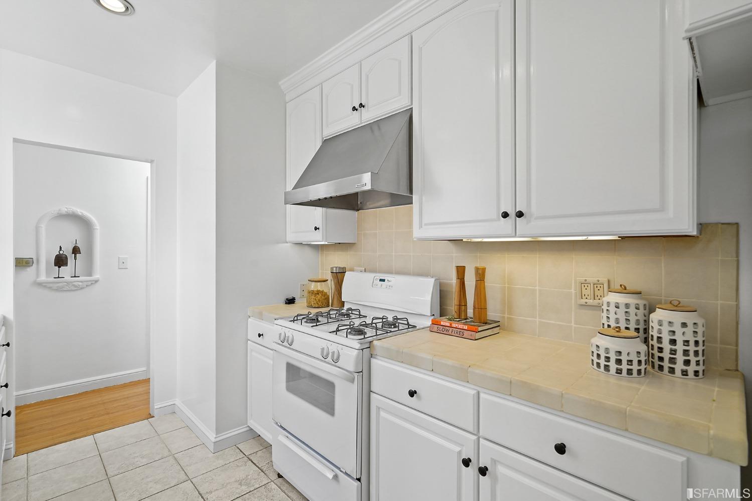 2290 Alemany Boulevard San Francisco, CA 94112 - Photo 27 of 45 a kitchen with white cabinets and appliances