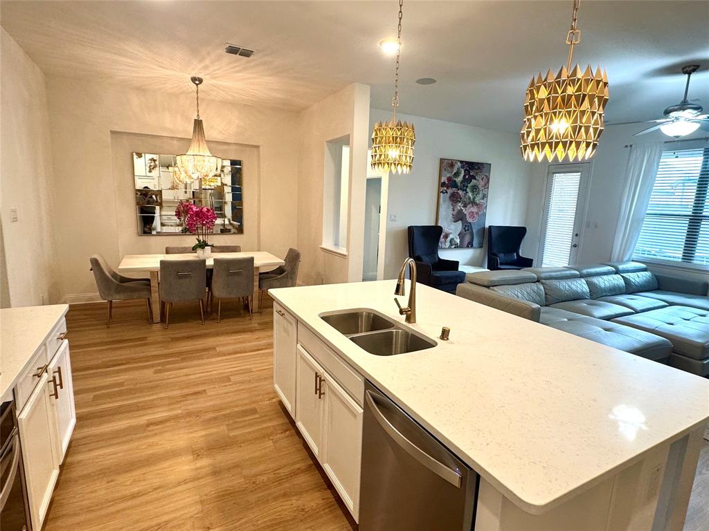 7024 Tree Stand Point Little Elm, TX 76227 - Photo 11 of 30 a very nice looking dining room with a kitchen island furniture and a chandelier
