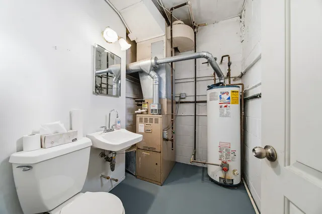 a kitchen with stainless steel appliances granite countertop a sink window and cabinets