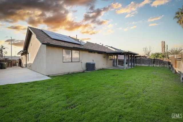a backyard of a house with table and chairs