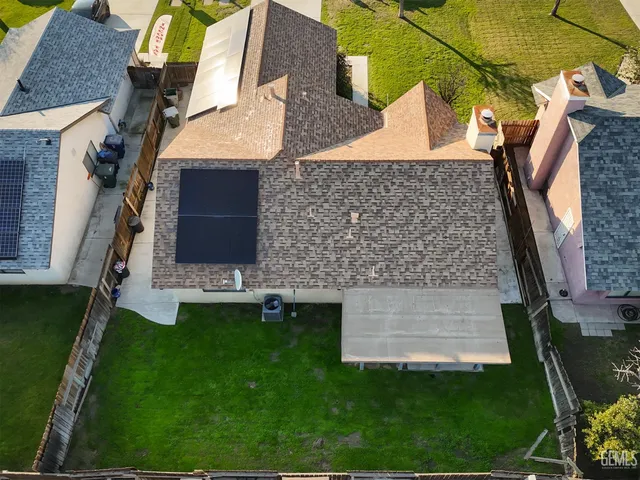 a aerial view of a house with a yard