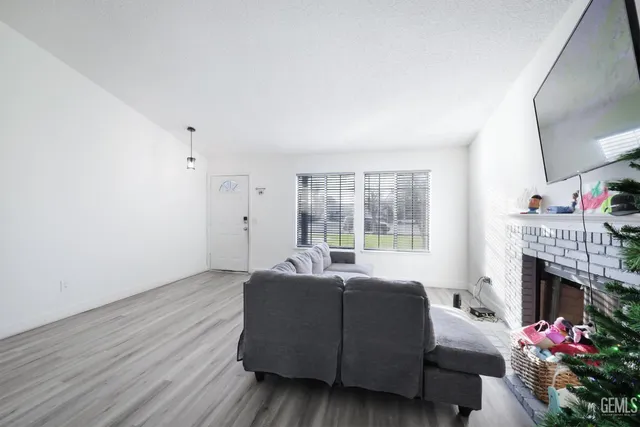 a living room with furniture a window and a fireplace
