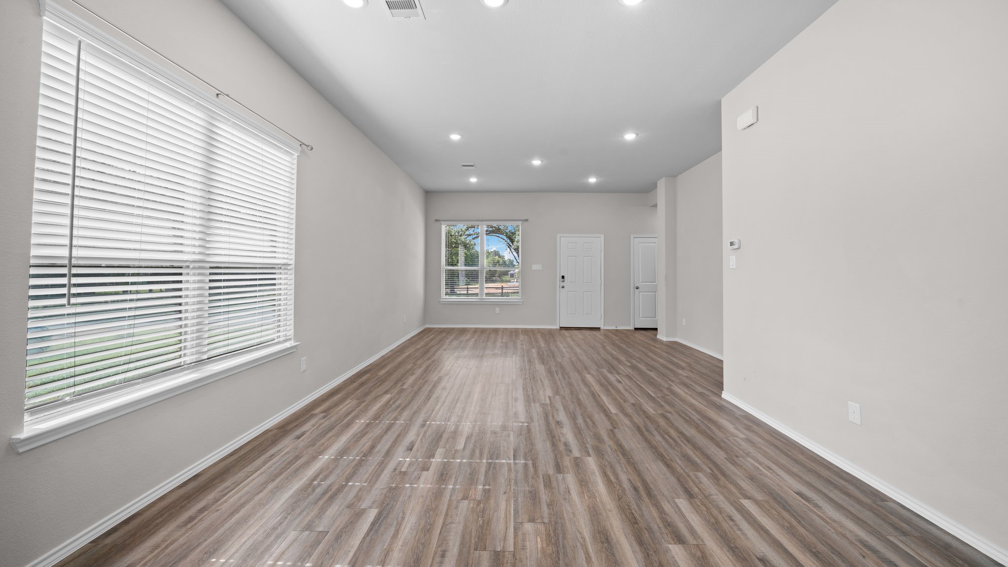 18140 Mail Rte Road Montgomery, TX 77316 - Photo 7 of 26 Generous living space with oversized windows, recessed lighting, and an open-concept design filled with natural light.