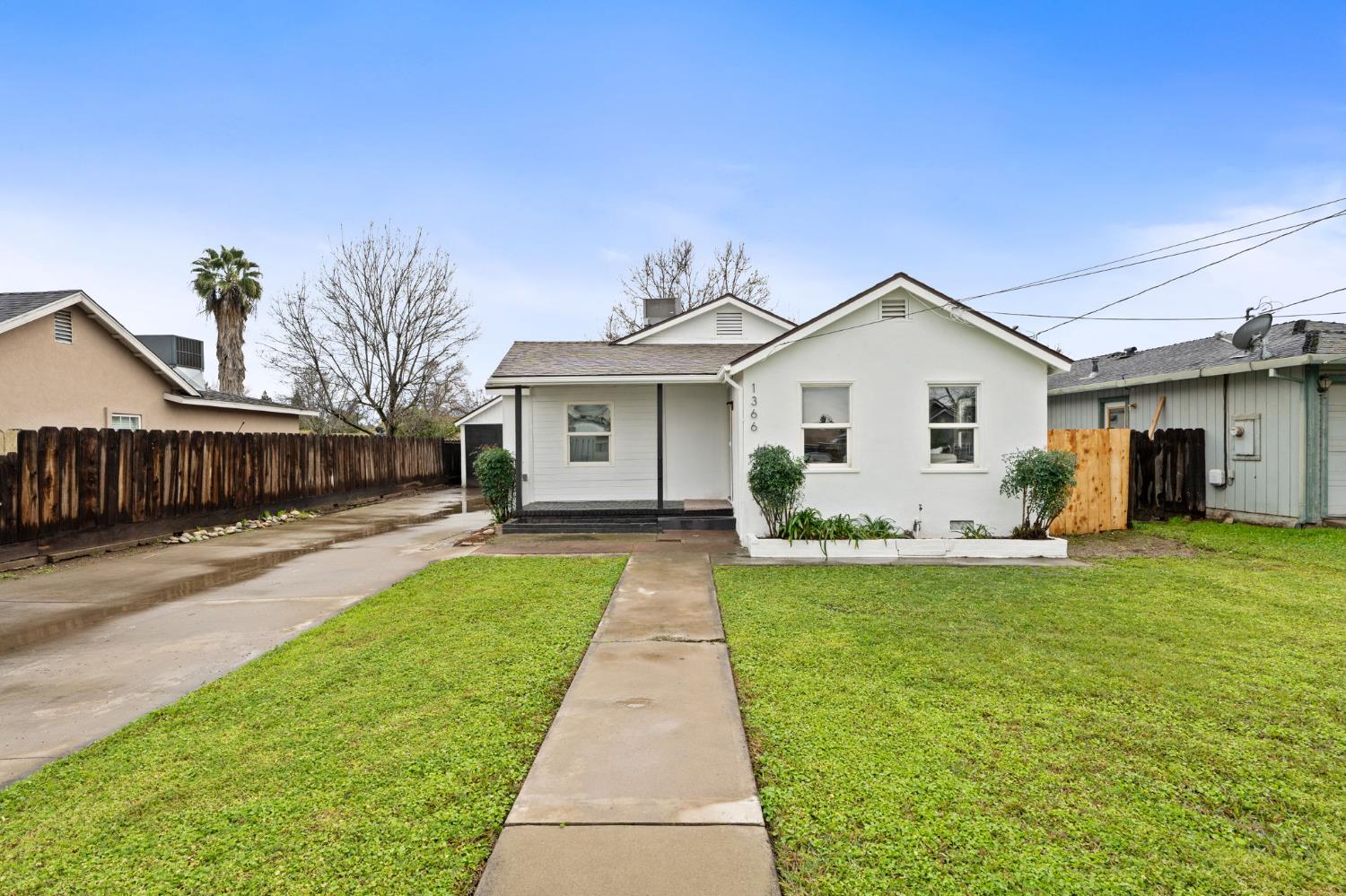 a front view of a house with a garden and yard