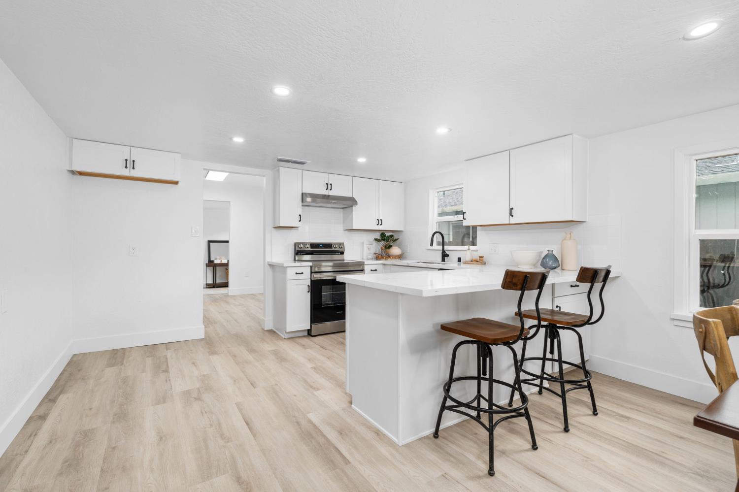 1366 East Alexander Avenue Merced, CA 95340 - Photo 12 of 30 a kitchen with granite countertop a sink cabinets and wooden floor
