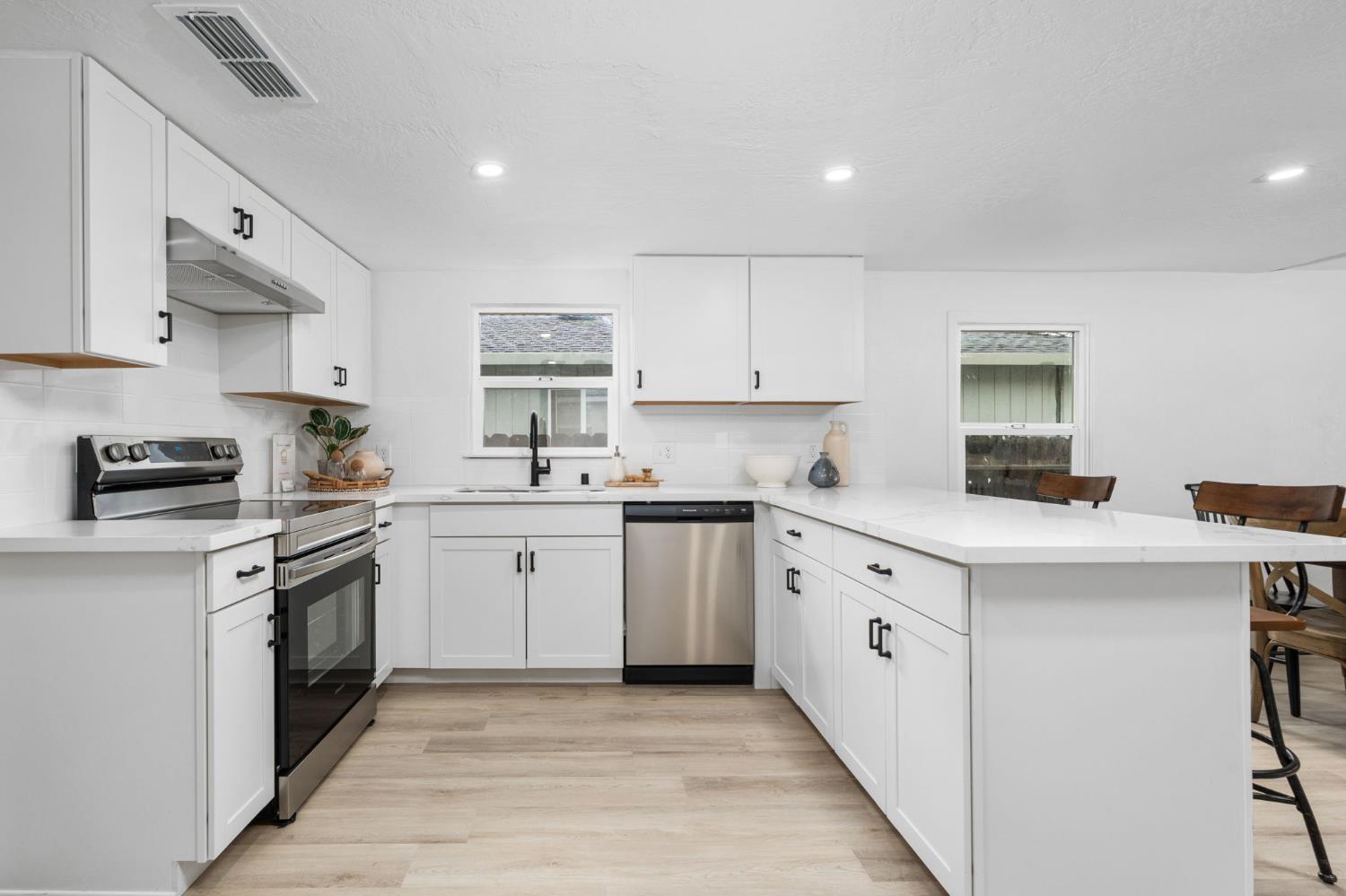 1366 East Alexander Avenue Merced, CA 95340 - Photo 14 of 30 a kitchen with cabinets appliances a sink and a counter top space