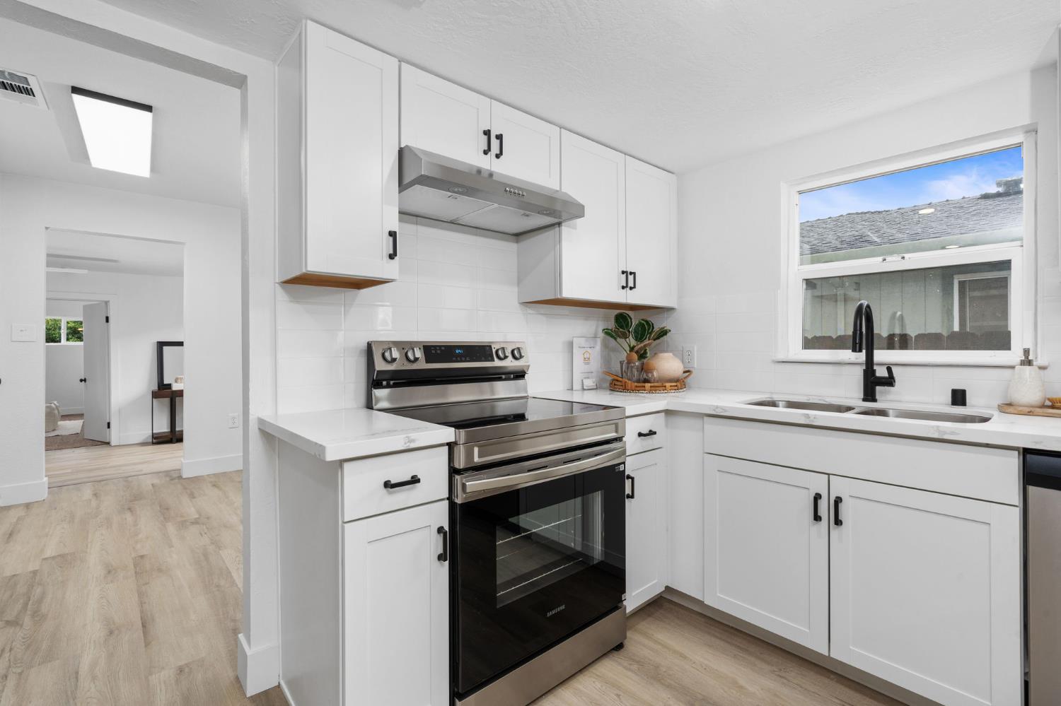 1366 East Alexander Avenue Merced, CA 95340 - Photo 15 of 30 a kitchen with cabinets appliances and a counter space