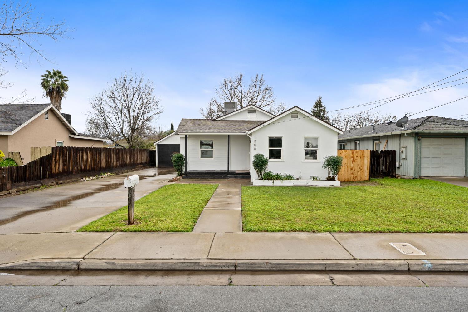 1366 East Alexander Avenue Merced, CA 95340 - Photo 2 of 30 a front view of a house with a garden and yard