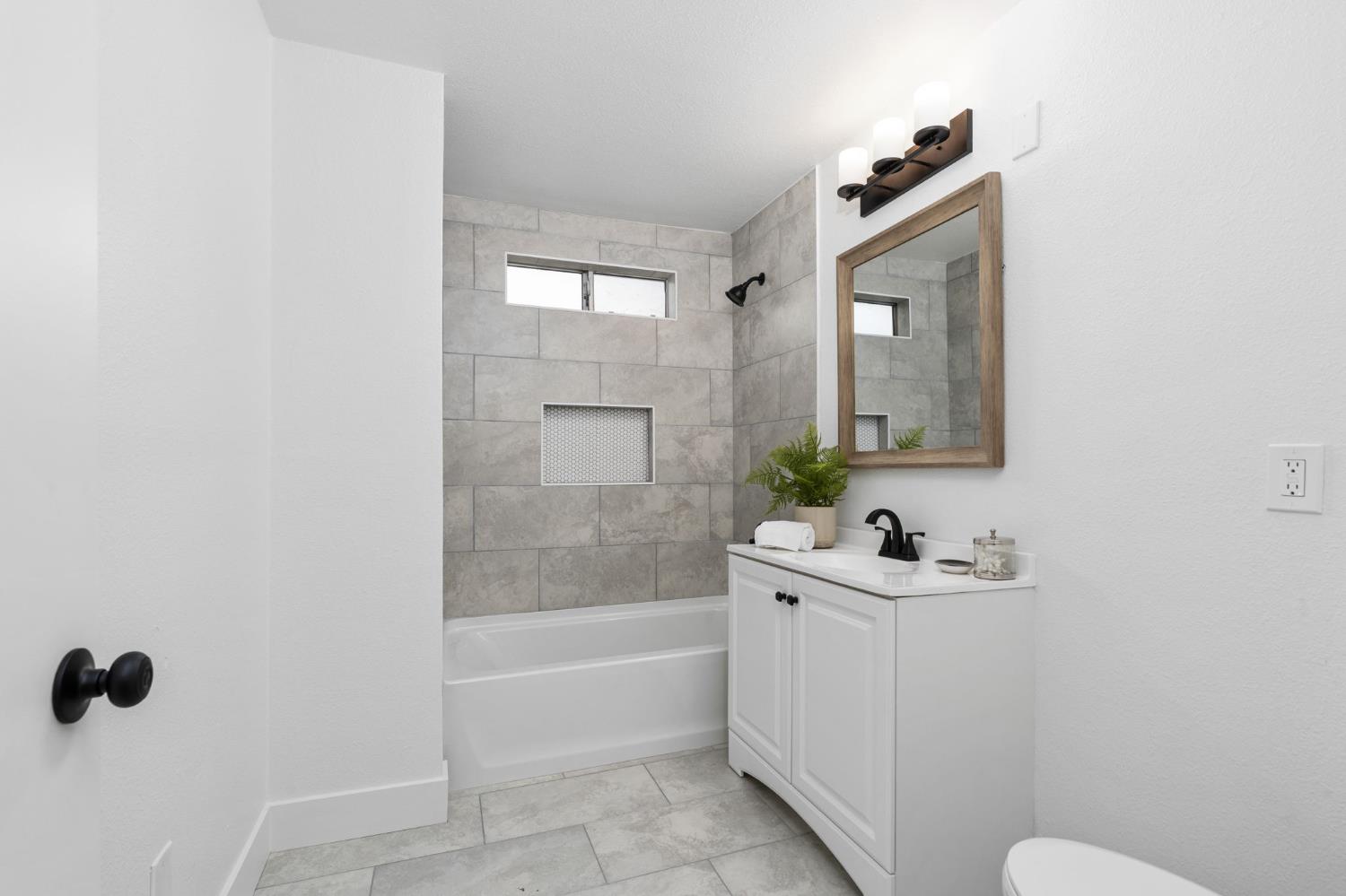 1366 East Alexander Avenue Merced, CA 95340 - Photo 21 of 30 a bathroom with a sink a toilet and shower
